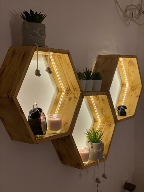 Hexagonal oak wall shelves styled with dried flowers and plants