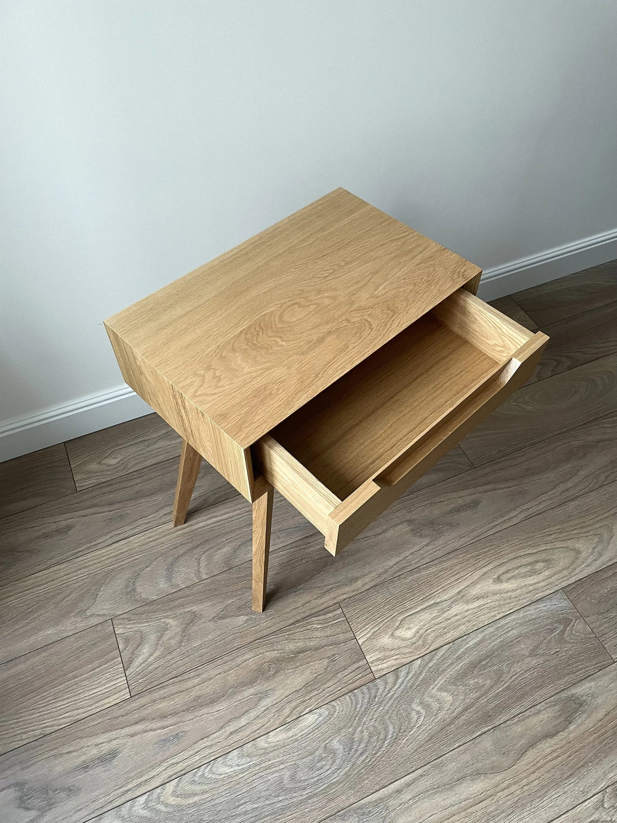 Oak side table with drawer open showing solid wood interior