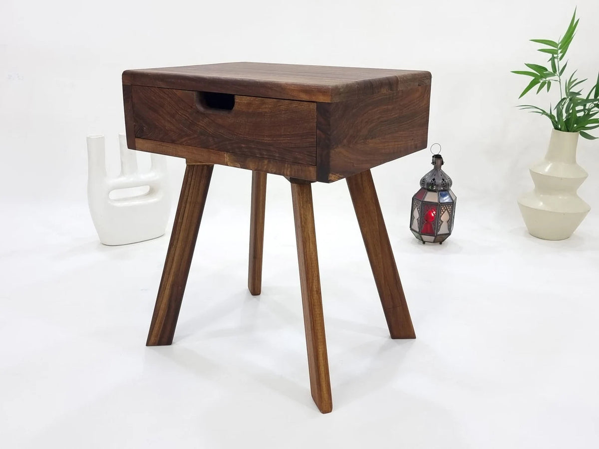 Solid walnut drawer side table with splayed legs and lantern beside it