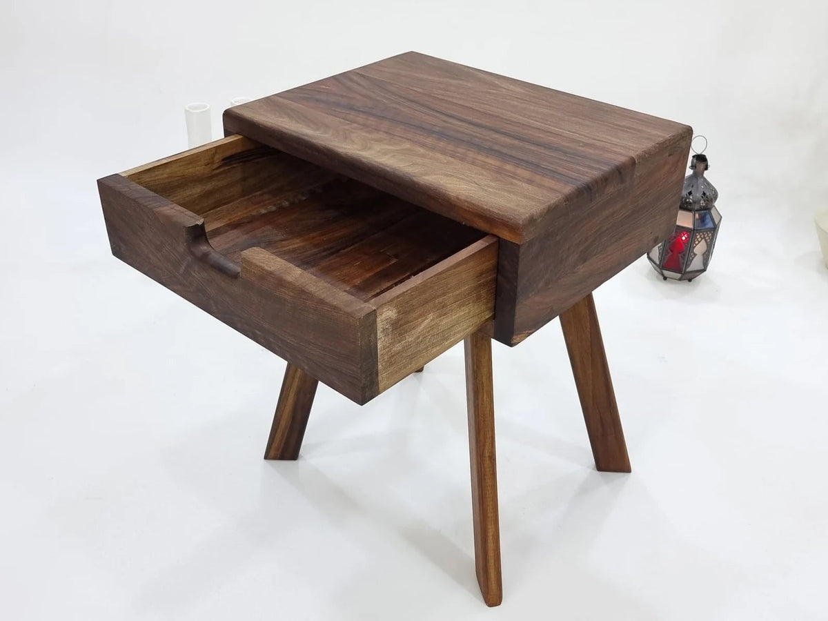 Walnut bedside table with drawer fully open showing solid wood interior
