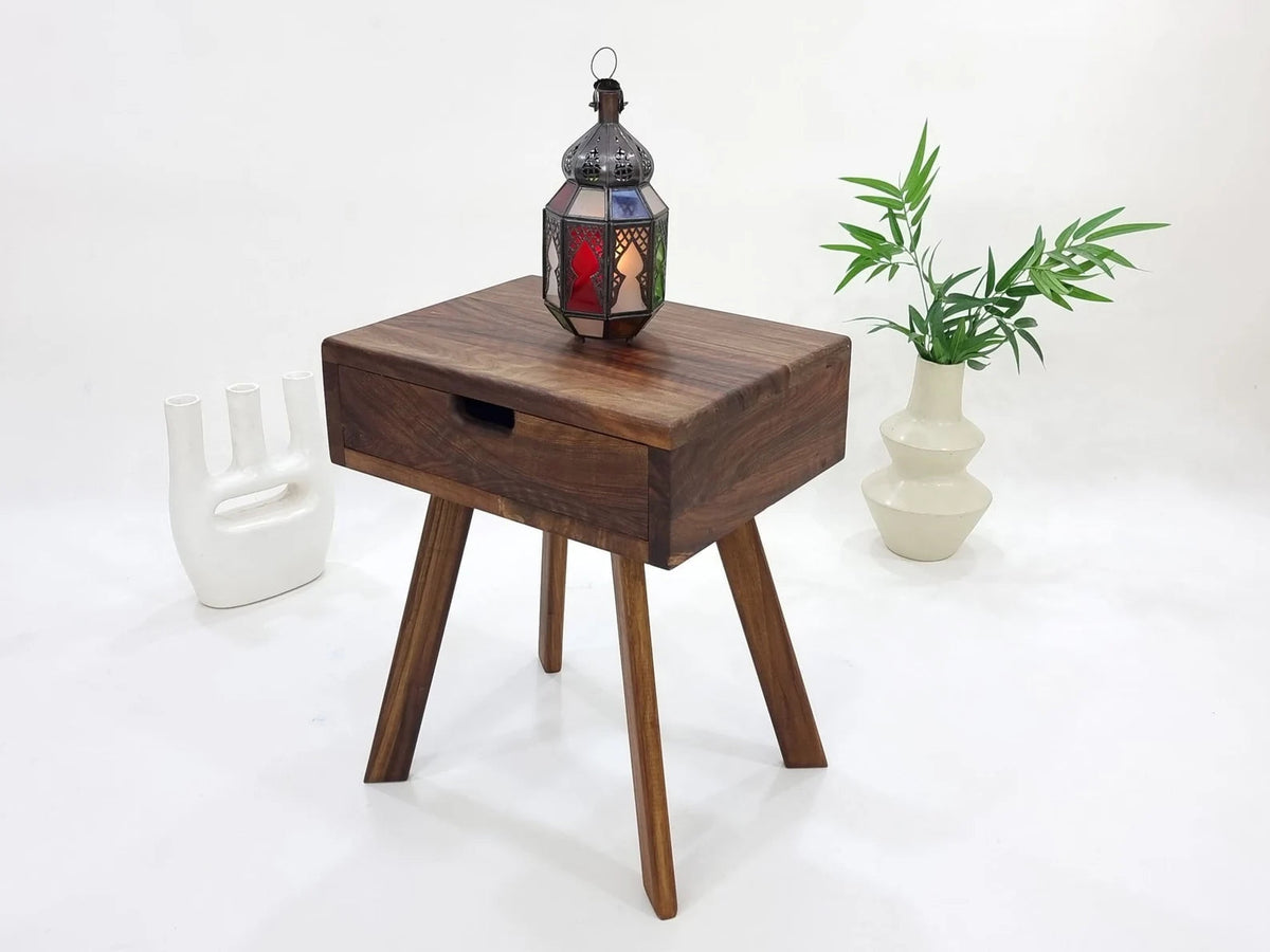 Dark walnut bedside table with Moroccan lantern and plant styling