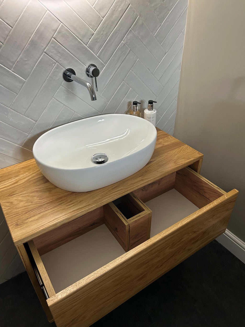 Floating oak bathroom vanity with drawer open - detail view
