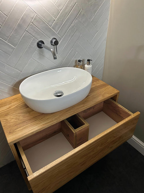 Floating oak bathroom vanity with drawer open - detail view