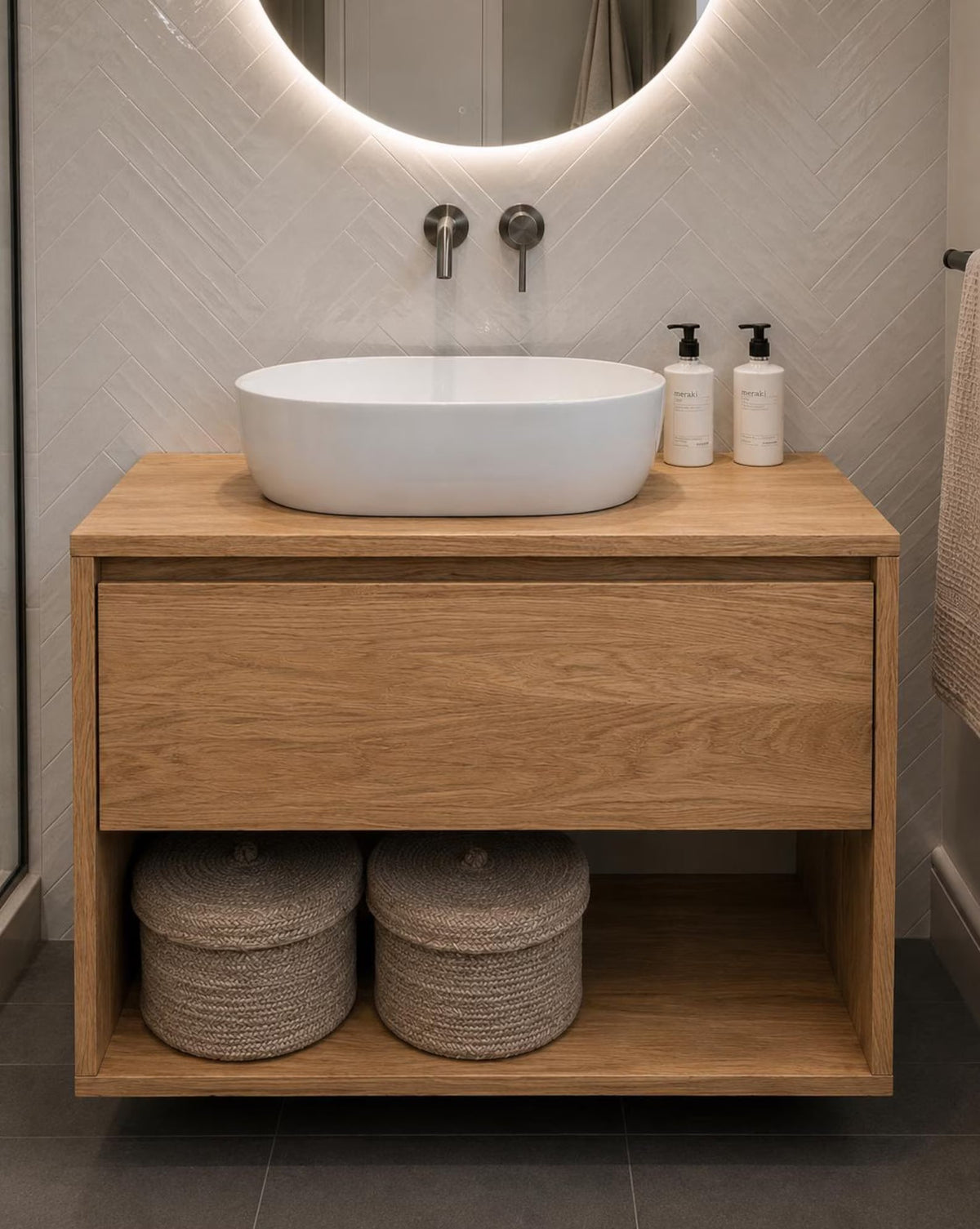 Floating oak bathroom vanity with round backlit mirror - full bathroom view